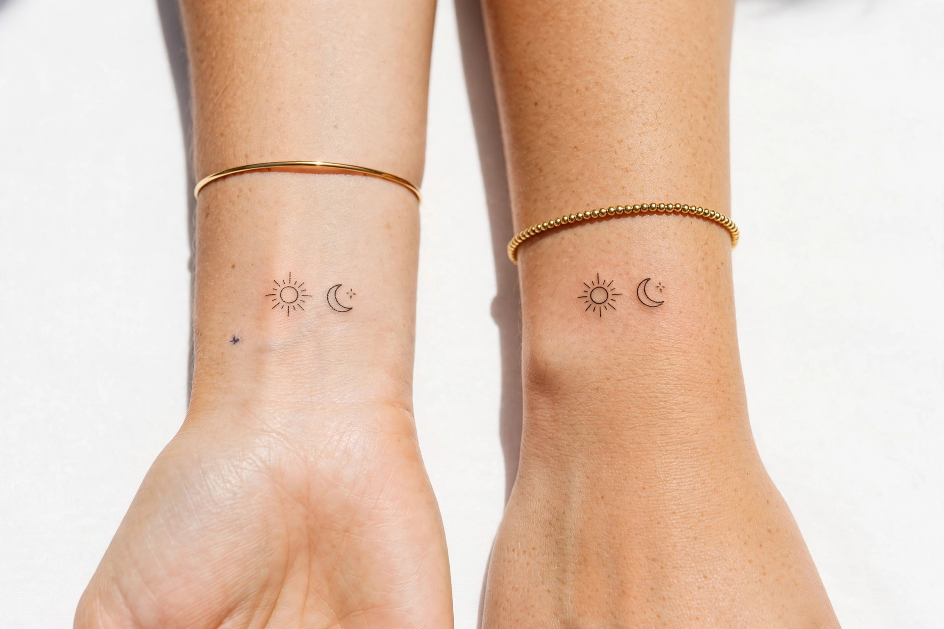 Matching small tattoos on two wrists